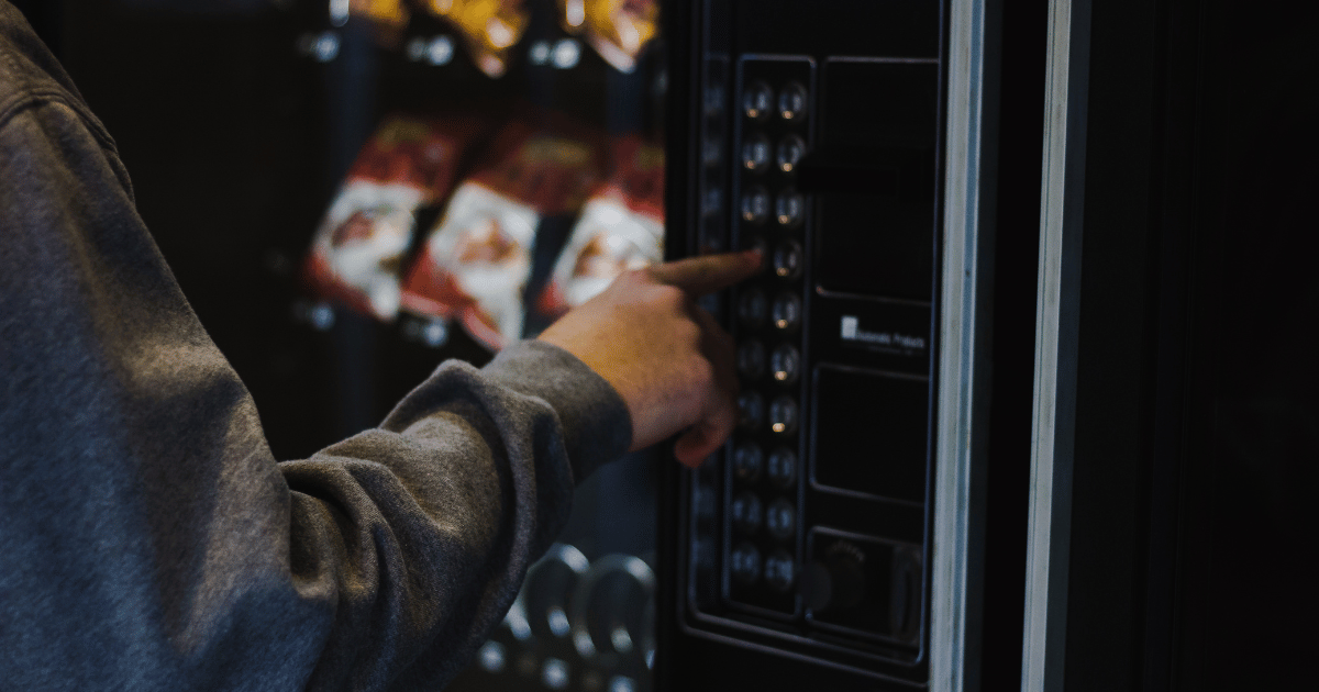 makeing a selection on a snack vending machine.