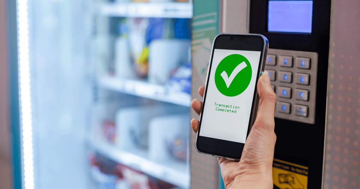 Purchasing a snack from a vending machine using touchless payment.